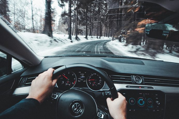person driving a volkswagen on a snowy cold road